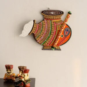 Matki Shape Wall Hanging Decor – Papier-Mache & Wood, Multicolor (35 x 28 cm)Decorative Matki-shape wall hanging made from papier-mache and wood. Multicolor finish. Size: 35 x 5 x 28 cm. Wipe clean only.This Matki-shape wall hanging is a decorative indoor wall decor piece made using papier-mache and wood. It features a multicolor finish in white, yellow, green, and orange, suitable for adding a traditional decorative accent to living rooms, entryways, hallways, bedrooms, or office spaces. For care, do not wash the item. Clean gently using a dry or slightly damp cotton cloth. Product Details: Product type: Wall hanging decor Shape/design: Matki shape Material: Wood and papier-mache Color: White, yellow, green, and orange Size (L x W x H): 35 cm x 5 cm x 28 cm (14" x 2" x 11.2") Recommended use: Indoor wall decor Care instructions: Do not wash; wipe with dry/wet cotton cloth Package Contents: 1 Matki-shape papier-mache wooden wall hanging